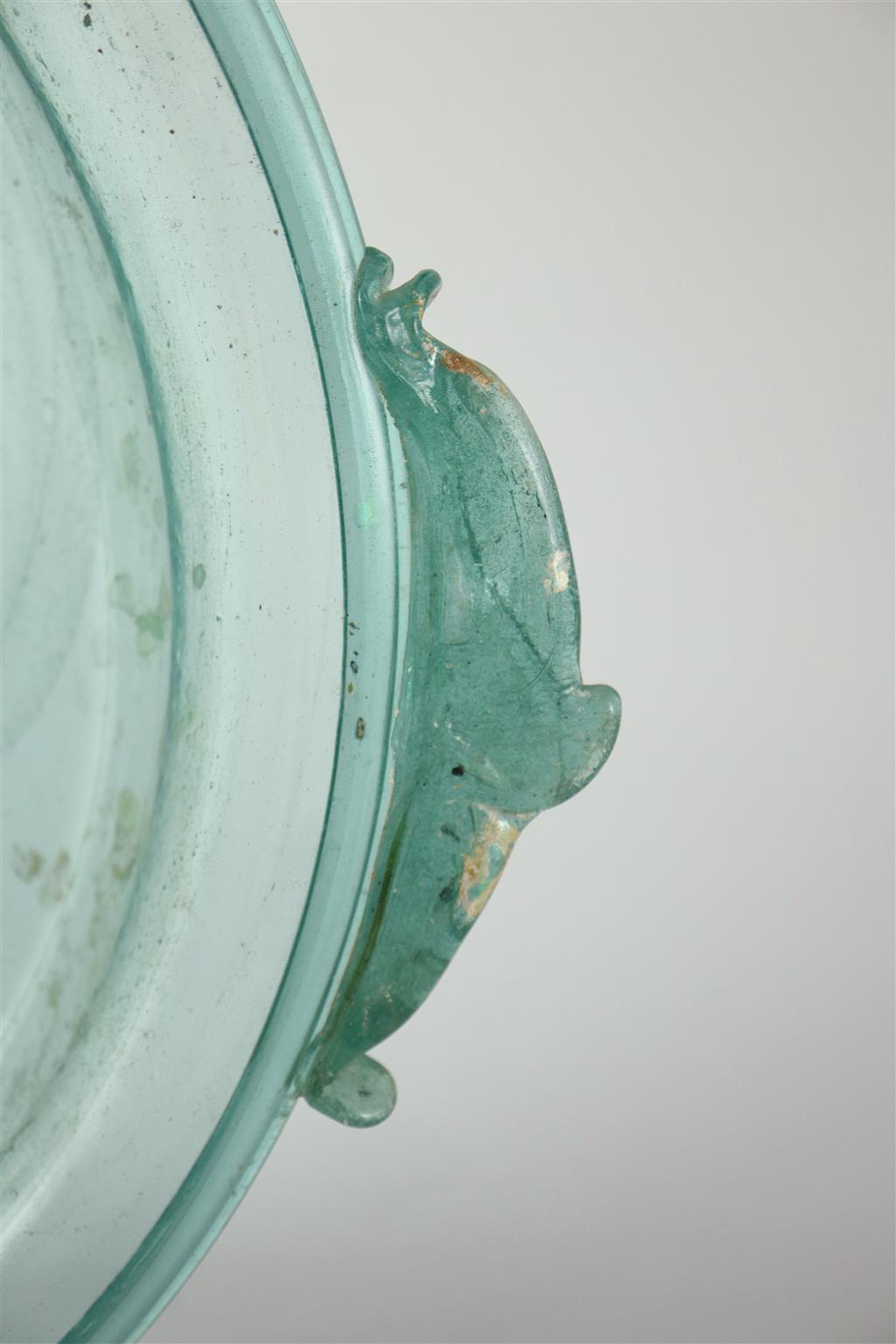 A Roman green glass dish, 1st/2nd century AD, 33cm across